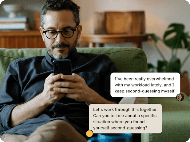 A man on a sofa reading a supportive message: let's work through this together