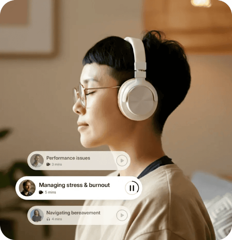 Someone listening through white headphones in a quiet bedroom