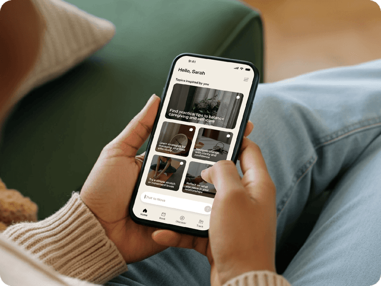 Hands holding a phone with wellbeing articles on screen